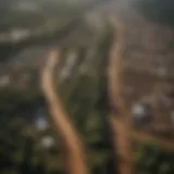 Aerial view of deforested land juxtaposed with factory farms